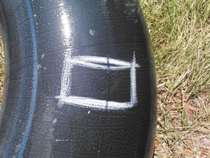 300x225 Hole marked, in Flat tractor tire, by John S. Quarterman, for OkraParadiseFarms.com, 3 September 2014