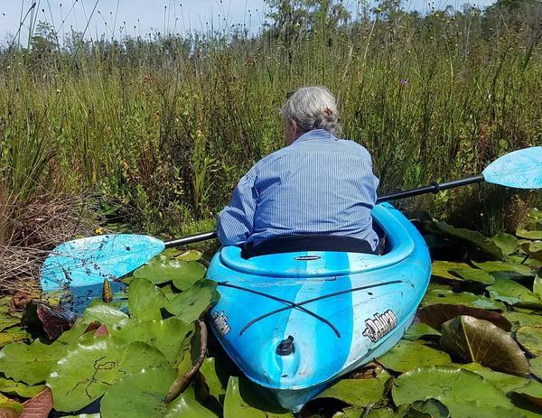 Gretchen picking some bog from the floating bottom