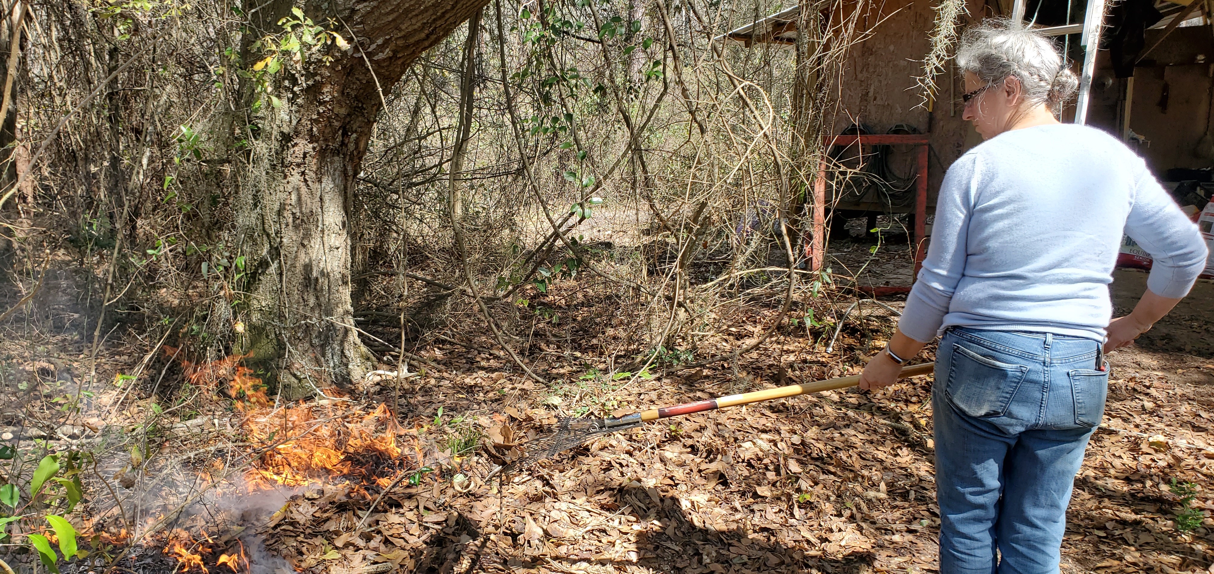 Gretchen spreading fire with a rake